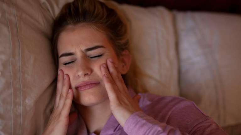 Lady with cheeks hurting