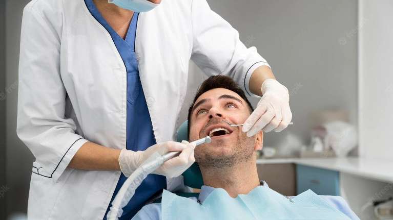Male patient being treated by dentist